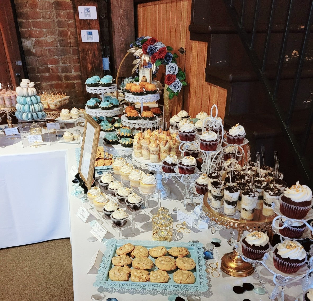 Vintage themed wedding dessert table with macarons, cupcakes, and cookies