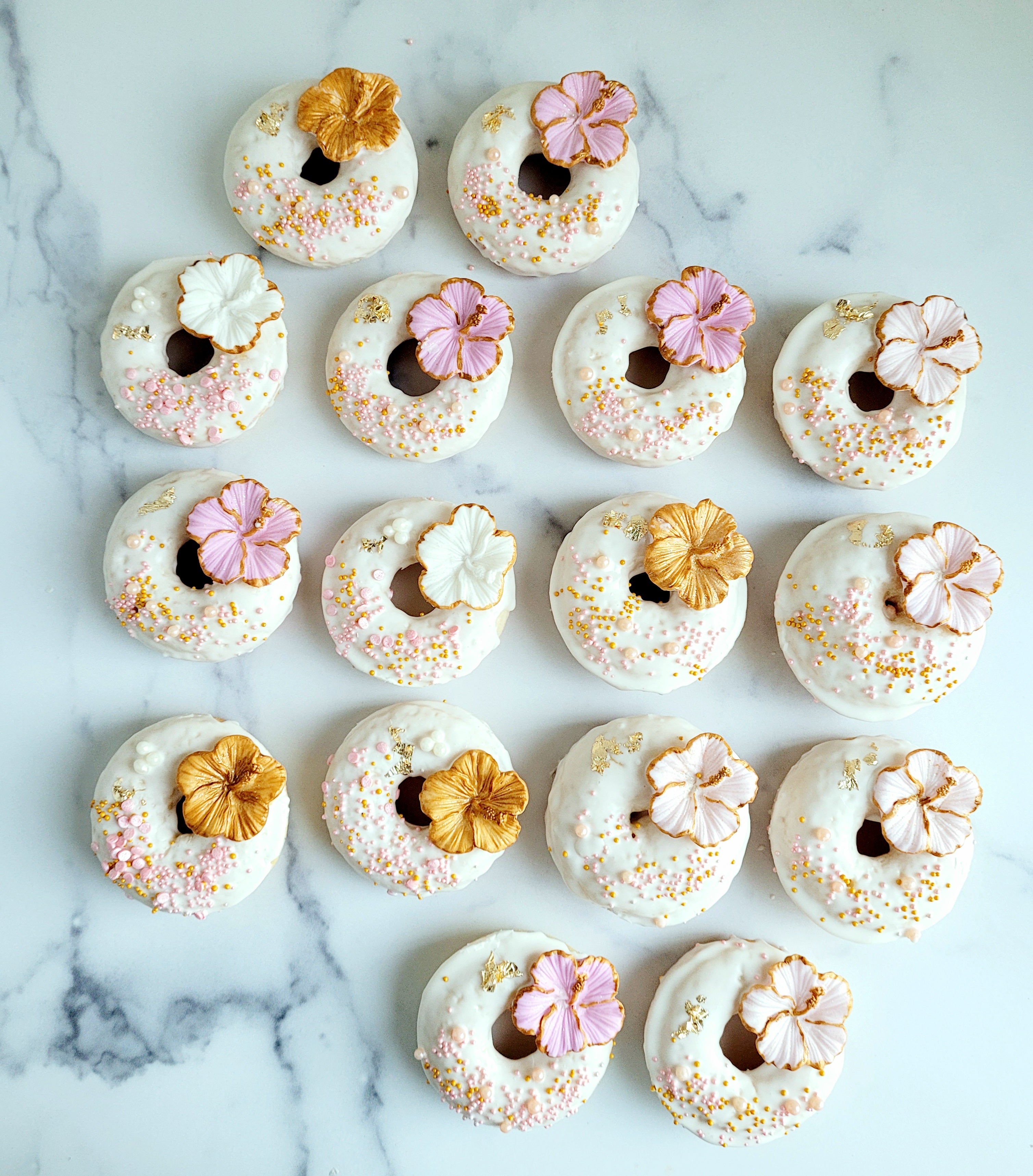 Customized donuts for a white, pink and gold wedding.